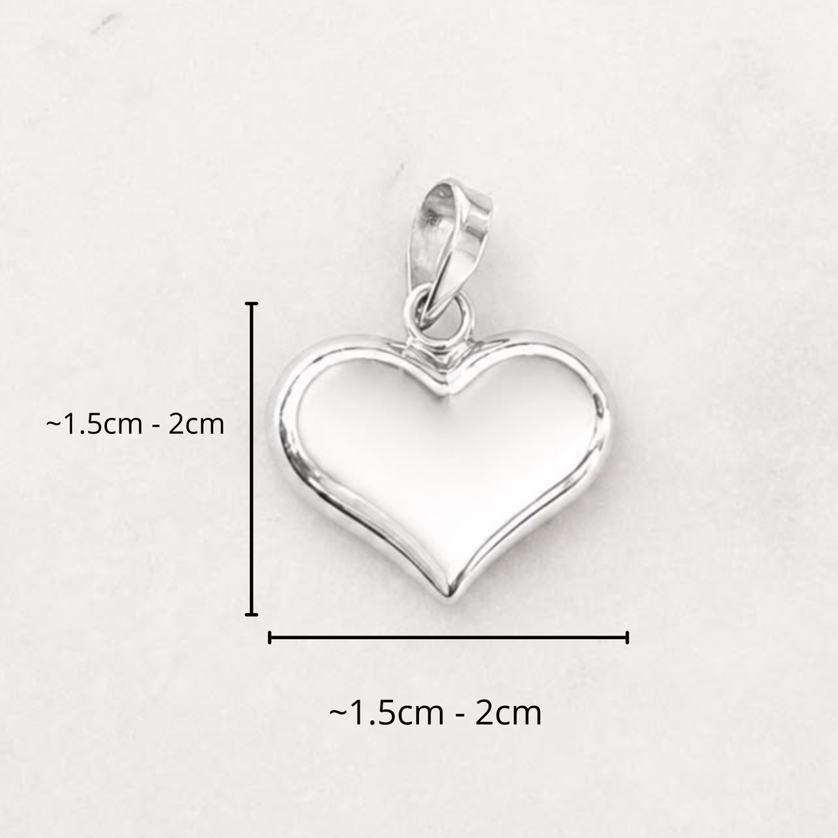 Large sterling silver puffed heart charm with a bail, shown with a 1.5cm to 2cm size guide